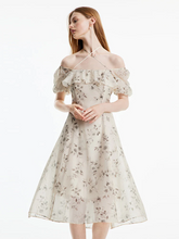 a lady in halter neck floral printed midi dress